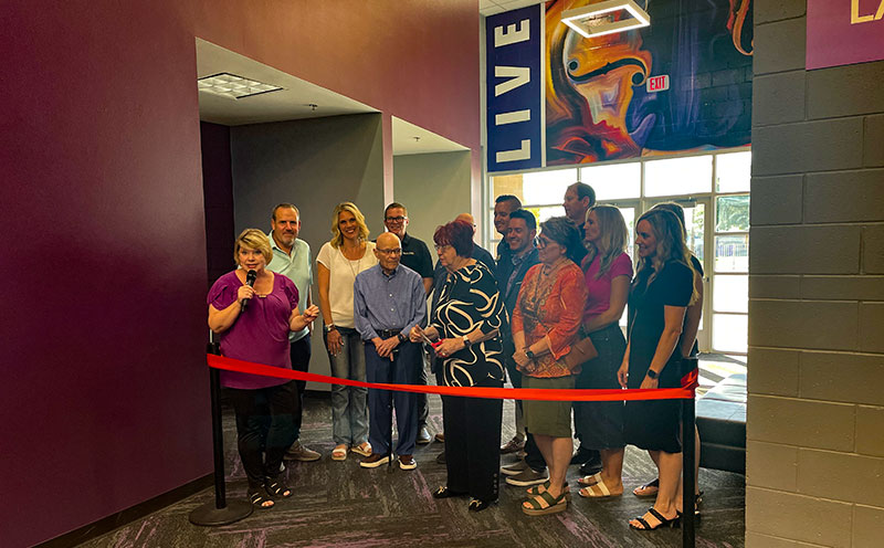Staff members cutting the ribbon for the newly renovated Performing Arts Center