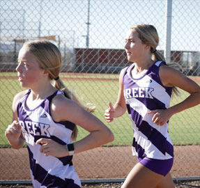 two qchs cross country runners